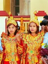 Young women in traditional costumes taking part in wedding ceremony at Mahamuni Pagoda, Mandalay, Myanmar