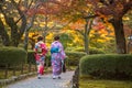 Young women in traditional Japanese dress walking in Kenrokuen Garden, Kanazawa