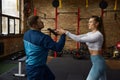 Young woman training self-defense from attacker with gun weapon Royalty Free Stock Photo