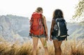 Young women traveling together into mountains