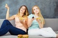 Young women with tv remote eating fast food Royalty Free Stock Photo