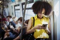 Young woman using a smartphone in the subway Royalty Free Stock Photo