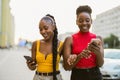 Young women using smartphones in the city Royalty Free Stock Photo