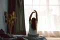 Young women wake up from sleep in the morning, stretch herself on the weekend on the bed. Relax and weekend concept Royalty Free Stock Photo