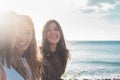 3 young women walk on the beach looking at each other, laughing and spending free time together. on a nice summer day. with sun Royalty Free Stock Photo