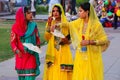 Young women walking and eating by Man Sagar Lake in Jaipur, India.