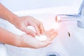 young women washing hands with soap rubbing fingers and skin under faucet water flows on white basin for pandemic prevention Royalty Free Stock Photo