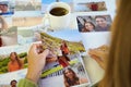 Young woman watching at her printed photos, remember nostalgia for a day of rest Royalty Free Stock Photo