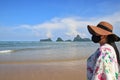 Young women wear a mask to prevent viral infection. But would like to come and relax by the sea during a short vacation Royalty Free Stock Photo