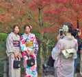 Young women wear a traditional dress called Kimono are taken a photo by their friend