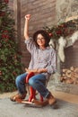 Laughing woman on wooden rocking horse Royalty Free Stock Photo