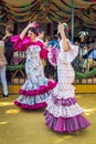 Young women wearing flamenco dresses and dancing `Sevillanas` at the April Fair, Seville Fair Feria de Sevilla.