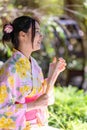 Young women wearing traditional Japanese kimono or yukata is happy and cheerful in the park Royalty Free Stock Photo