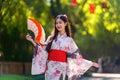 Young women wearing traditional Japanese kimono or yukata is happy and cheerful in the park Royalty Free Stock Photo