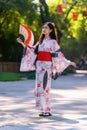 Young women wearing traditional Japanese kimono or yukata is happy and cheerful in the park Royalty Free Stock Photo