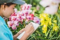 Young women write note among orchid garden. Colorful orchids, Orchid flower bloom Royalty Free Stock Photo