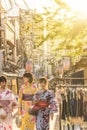 Young women in yukata in the the old-fashionned shopping street Yanaka Ginza famous as a spectacular spot for sunset. Yanaka Ginza