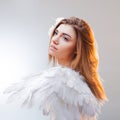 Young, wonderful blonde girl in the image of an angel with white wings. Royalty Free Stock Photo