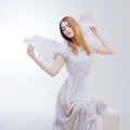 Young, wonderful blonde girl in the image of an angel with white wings. Royalty Free Stock Photo