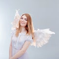An angel from heaven. Young, wonderful blonde girl in the image of an angel with white wings. Royalty Free Stock Photo