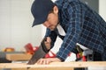 Young woodworker using hand saw Royalty Free Stock Photo