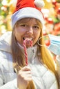 Young wooman near a shop window decorated for christmas and new year. Royalty Free Stock Photo