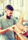 Young worker in a carpenters workshop Royalty Free Stock Photo