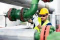 Worker closes the valve on the oil pipeline