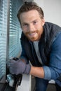 young worker cutting seal for installation new window