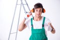 The young worker with earmuffs in noise cancelling concept Royalty Free Stock Photo