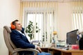 Young worker having break and resting after solving task Royalty Free Stock Photo