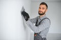 Young worker making repair in room. Royalty Free Stock Photo