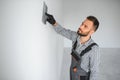 Young worker making repair in room. Royalty Free Stock Photo