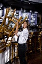 Young worker taking down bar stools