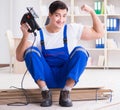 Young worker working on floor laminate tiles Royalty Free Stock Photo