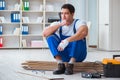 The young worker working on floor laminate tiles Royalty Free Stock Photo
