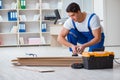 The young worker working on floor laminate tiles Royalty Free Stock Photo