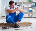 Young worker working on floor laminate tiles Royalty Free Stock Photo