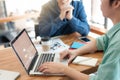 Young workers discussing with coworker in meeting room