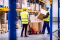 Young workers in a warehouse. Royalty Free Stock Photo