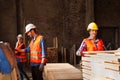 Young workers working in wood factory manufacturing. Workers wears protected helmet, gloves and clothes.