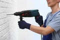 Young working man using rotary hammer. Home repair Royalty Free Stock Photo