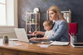 Young working mother spending time with baby