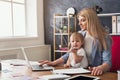 Young working mother spending time with baby