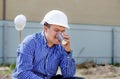 Young workman sipping coffee on a building site