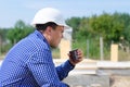 Young workman sipping coffee on a building site