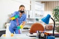 Workwoman of cleaning service in protective mask mopping floors in office Royalty Free Stock Photo