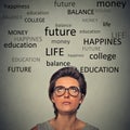 Young worried woman with glasses planning future life looking up