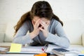 Young worried woman suffering stress doing domestic accounting paperwork bills Royalty Free Stock Photo