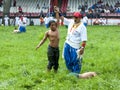 A young wrestler is awarded victory at the Kirkpinar Turkish Oil Wrestling Festival in Edirne in Turkey. Royalty Free Stock Photo